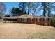 Charming brick home featuring a cozy carport and a well-manicured front lawn at 1276 Kingsview Se Cir, Smyrna, GA 30080