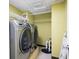 Bright laundry room with modern washer/dryer units and ample shelving, offering convenience and organization at 1276 Kingsview Se Cir, Smyrna, GA 30080