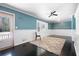 Bright living room with blue walls, a ceiling fan, and dark hardwood floors at 1276 Kingsview Se Cir, Smyrna, GA 30080