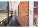 Covered porch with decorative iron railings along brick wall at 1276 Kingsview Se Cir, Smyrna, GA 30080
