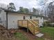 Backyard view of the home's new wooden deck and the surrounding landscaped yard at 147 Mildred Ct, Dallas, GA 30157