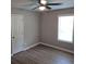 Neutral bedroom with wood-look flooring, ceiling fan, a window with blinds, and a closet at 147 Mildred Ct, Dallas, GA 30157