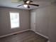 Neutral bedroom with wood-look flooring, ceiling fan, a window with blinds, and a closet at 147 Mildred Ct, Dallas, GA 30157