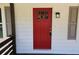 Close-up of the red front door with a glass pane and black lantern at 147 Mildred Ct, Dallas, GA 30157