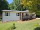 Charming single-story home featuring white siding, dark shutters and a cozy front deck at 147 Mildred Ct, Dallas, GA 30157