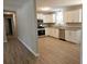 Kitchen with stainless appliances, white cabinets and sink, with a view of the living room at 147 Mildred Ct, Dallas, GA 30157