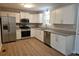 Spacious kitchen with stainless steel appliances, granite countertops, and light wood floor at 147 Mildred Ct, Dallas, GA 30157