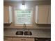 Close-up on modern, stainless-steel, double bowl kitchen sink and granite counters at 147 Mildred Ct, Dallas, GA 30157