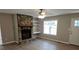 Living room featuring a stone fireplace, hardwood floors, and a ceiling fan at 147 Mildred Ct, Dallas, GA 30157