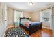 Bright bedroom with hardwood floors, a comfortable bed, and natural light from two windows at 2114 Fellowship Rd, Tucker, GA 30084