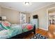 Comfortable bedroom featuring hardwood floors, a colorful bedspread, and natural light from windows at 2114 Fellowship Rd, Tucker, GA 30084