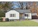 Charming cottage-style home with white siding, wood shutters, and a well-manicured front yard at 2114 Fellowship Rd, Tucker, GA 30084