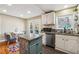 Bright kitchen with a dining area, stainless steel appliances, and access to the outdoor deck at 2114 Fellowship Rd, Tucker, GA 30084
