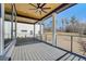 An ample back porch featuring a ceiling fan and view of a bright, sunny day and backyard at 2551 Kilgore Rd, Buford, GA 30519