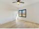 Modern bedroom features hardwood floors, ceiling fan, and natural light through large window at 2551 Kilgore Rd, Buford, GA 30519