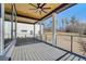 Spacious covered deck featuring wood ceiling, ceiling fan, and iron railing overlooking the backyard at 2551 Kilgore Rd, Buford, GA 30519