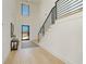 Bright entryway with modern staircase, blonde wood floors, and high ceilings for a grand and inviting entrance at 2551 Kilgore Rd, Buford, GA 30519