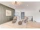Bright open loft featuring modern decor, accent wall, comfortable seating, and natural light at 2551 Kilgore Rd, Buford, GA 30519