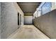 Covered outdoor patio with brick siding, concrete floor, and metal railing, ideal for outdoor seating and entertaining at 2551 Kilgore Rd, Buford, GA 30519