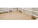 Spacious walk-in closet with custom shelves and wood flooring creates a neat, organized space for storage at 2551 Kilgore Rd, Buford, GA 30519