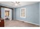 Bedroom featuring neutral walls, connecting room, and natural light from window at 4987 Main St, Union City, GA 30291