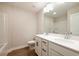 Bathroom featuring a double sink vanity, white cabinets, and wood look floors at 121 Priestwood Ln, Acworth, GA 30102