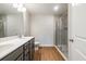Bathroom features a double sink vanity, a walk-in shower, and wood plank flooring at 121 Priestwood Ln, Acworth, GA 30102