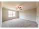 Large bedroom with a ceiling fan and a large window overlooking a green area at 121 Priestwood Ln, Acworth, GA 30102