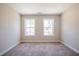 Bedroom with neutral colored walls and carpet and two windows at 121 Priestwood Ln, Acworth, GA 30102