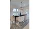Dining room featuring a black dining table with gold-legged chairs and modern lighting at 121 Priestwood Ln, Acworth, GA 30102