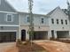 New townhomes with brick and siding exteriors, featuring open garages and landscaped front yards at 121 Priestwood Ln, Acworth, GA 30102