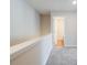 Upstairs hallway with neutral walls, carpet, and a view of the bathroom at 121 Priestwood Ln, Acworth, GA 30102
