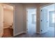 Hallway features neutral walls, gray carpet, and doorways leading to a bathroom and bedrooms at 121 Priestwood Ln, Acworth, GA 30102