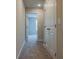 Carpeted hallway with two doors to the right, the front one slightly ajar at 121 Priestwood Ln, Acworth, GA 30102