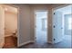 Hallway with neutral walls, carpet, and several doorways leading to rooms at 121 Priestwood Ln, Acworth, GA 30102