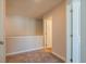 Hallway with neutral paint, carpet, and trim, with a view into a bedroom at 121 Priestwood Ln, Acworth, GA 30102