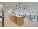 Open kitchen with center island, modern pendant lighting, and views into the living room at 121 Priestwood Ln, Acworth, GA 30102