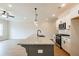 Kitchen island featuring granite countertops, pendant lighting, and stainless steel appliances at 121 Priestwood Ln, Acworth, GA 30102