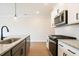 Modern kitchen features stainless steel appliances, granite countertops, and ample cabinet space at 121 Priestwood Ln, Acworth, GA 30102
