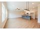 Open-concept living room boasts wood floors, natural light, and a modern island with granite countertops at 121 Priestwood Ln, Acworth, GA 30102