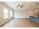 Bright living area featuring hardwood floors and natural light, complemented by a ceiling fan at 121 Priestwood Ln, Acworth, GA 30102