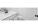Elegant half bathroom featuring a modern vanity with black hardware and a sleek toilet at 3188 Eastham Run Dr, Dacula, GA 30019