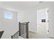 Upstairs hallway with carpet and view of window and doorway at 3188 Eastham Run Dr, Dacula, GA 30019