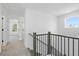 Upstairs hallway with carpet and view of doorways and windows at 3188 Eastham Run Dr, Dacula, GA 30019