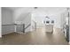 Open-concept living room with wood floors, bright windows, and a staircase leading upstairs at 3188 Eastham Run Dr, Dacula, GA 30019
