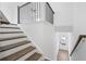 Staircase with metal railing leading down, providing access to the lower level with outside entry at 3188 Eastham Run Dr, Dacula, GA 30019