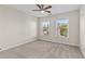 Bedroom with neutral walls, carpeted floor, ceiling fan, and windows offering natural light at 4831 Edinburgh Dr, Smyrna, GA 30082