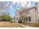 Elegant back exterior featuring multiple windows, a cozy deck, and well-maintained landscaping at 5825 Laurel Oak Dr, Suwanee, GA 30024