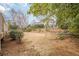 This backyard has landscaping and a cascading water feature, with a view of the home at 5825 Laurel Oak Dr, Suwanee, GA 30024