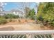This backyard has landscaping and a cascading water feature, with a view of the home at 5825 Laurel Oak Dr, Suwanee, GA 30024